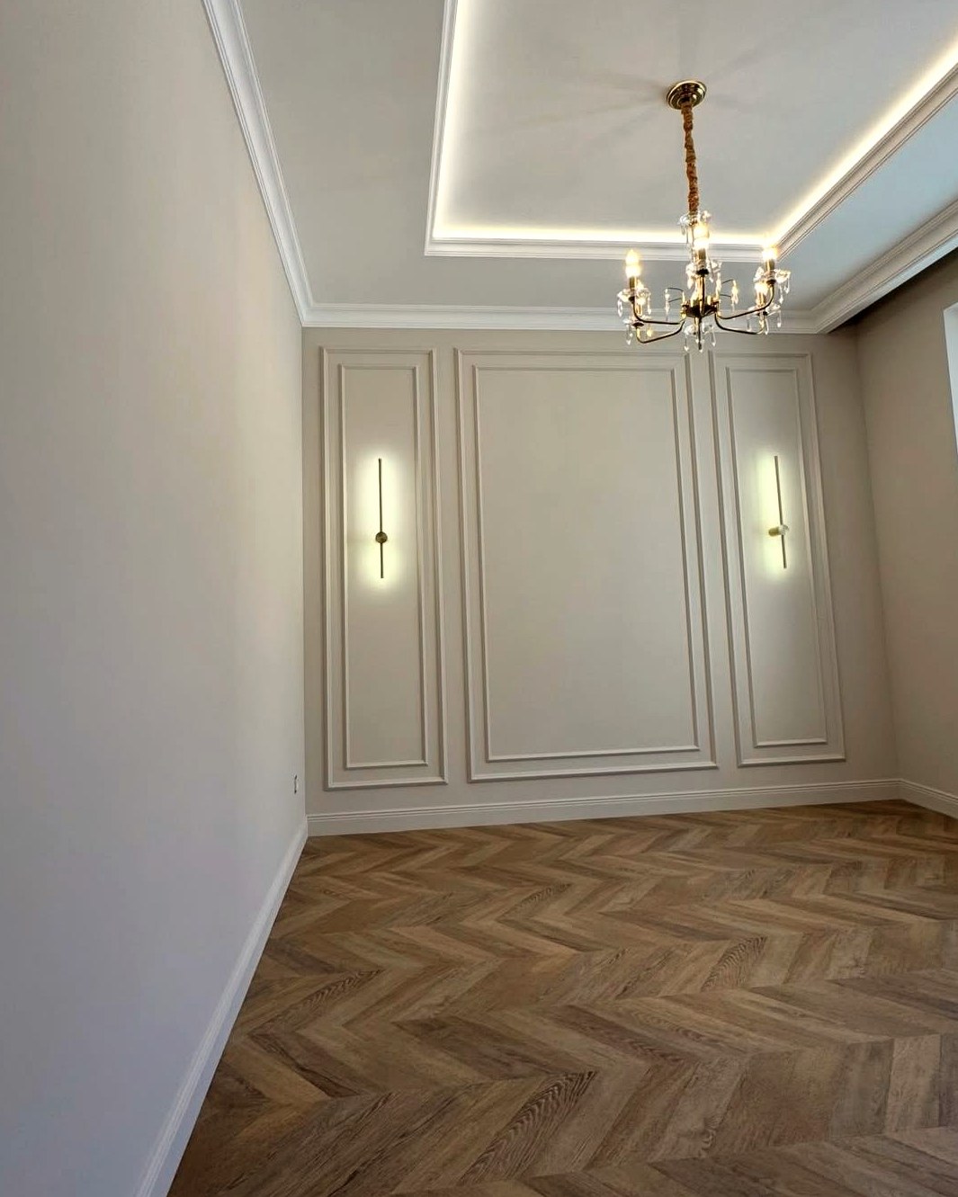 Camera con boiserie, cornici in gesso e luce LED a soffitto